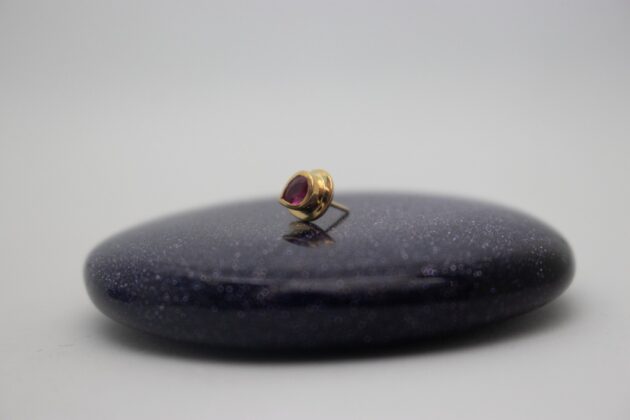 gold piercing jewelry by NAGA jewelry organics set with a genuine ruby