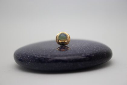 gold piercing jewelry by NAGA jewelry organics set with a genuine white opal