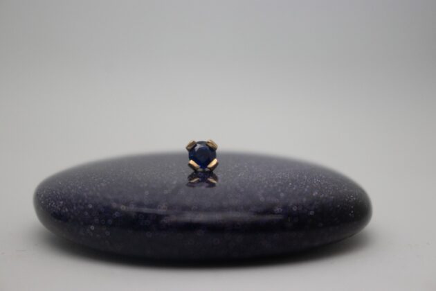 gold piercing jewelry by NAGA jewelry organics. gold claw set featuring a genuine dark blue sapphire