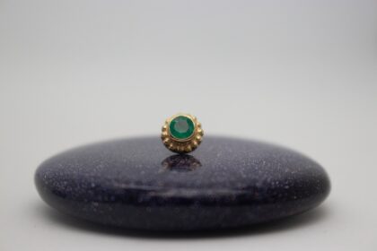 gold piercing jewelry by NAGA jewelry organics. genuine emerald set in yellow gold surrounded by beads of yellow gold