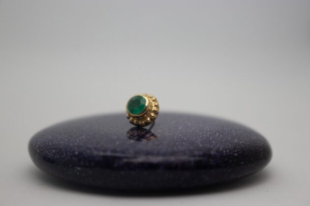 gold piercing jewelry by NAGA jewelry organics. genuine emerald set in yellow gold surrounded by beads of yellow gold